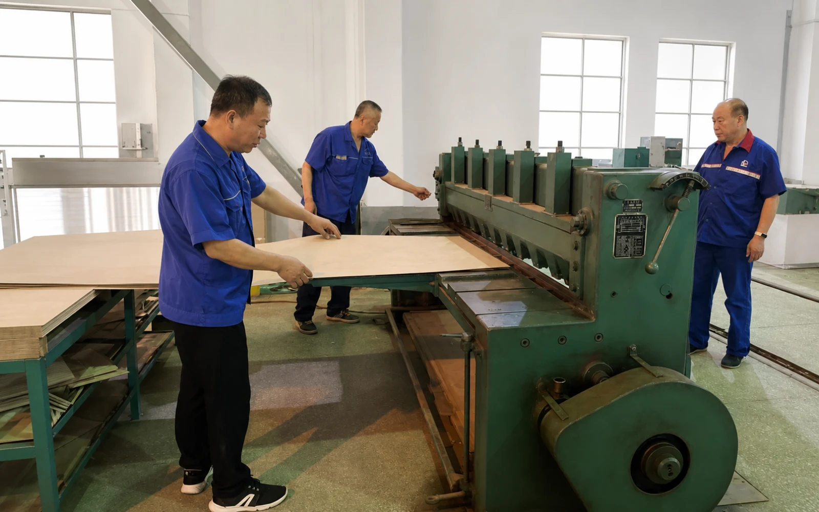 Operators preparing insulation board in the transformer workshop